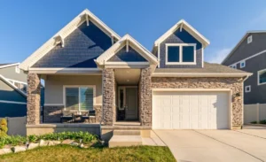 Photo of the front of a stone and siding house